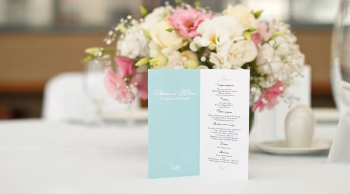 Menu card with beautiful flowers on table in wedding day at Lakeside Weddings