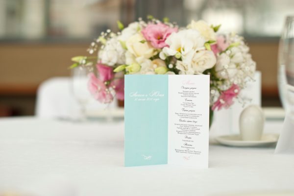 Menu card with beautiful flowers on table in wedding day at Lakeside Weddings