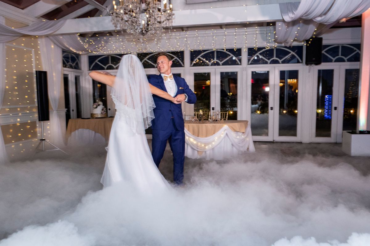 Bride and groom dancing at reception with fog effect