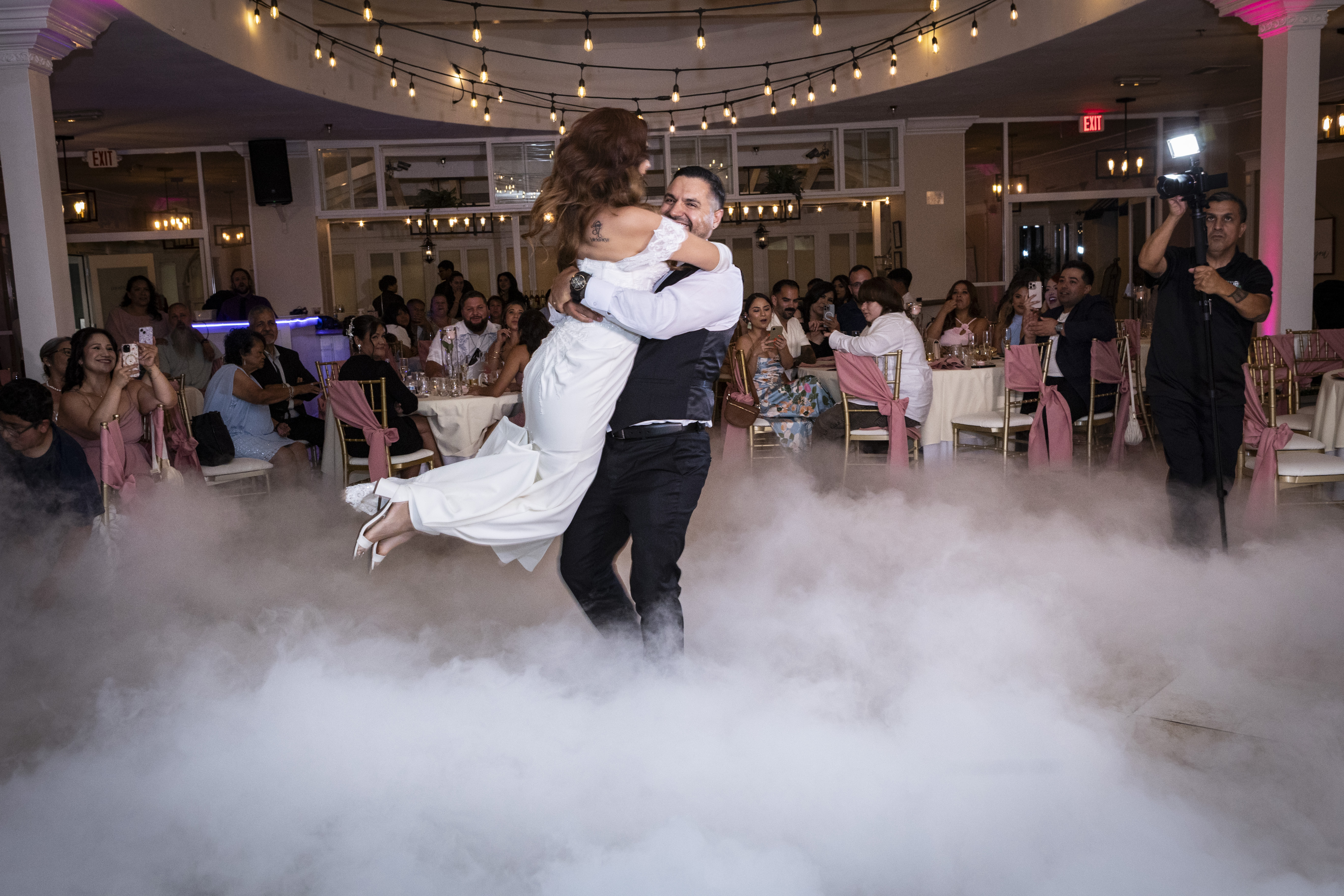 Couple dancing at their lakeside reception